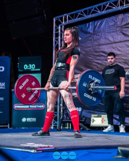 Emily Westray stands at the top of the deadlift manoeuvre holding a bar with weight of 110kg.