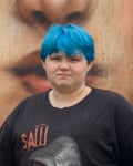 Portrait of a teenager with short blue hair and a black T-shirt