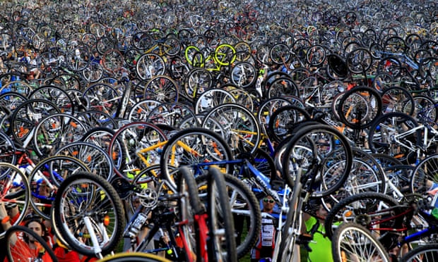 Thousands of cyclists hold up their bicycles after a Critical Mass rise in Budapest.