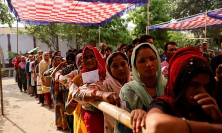 People line up as they wait to vote in Uttar Pradesh