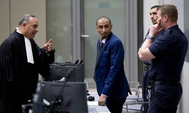 Al Hassan Ag Abdoul Aziz Ag Mohamed Ag Mahmoud (centre) listens as his counsel talks to security guards at the ICC in April 2018.