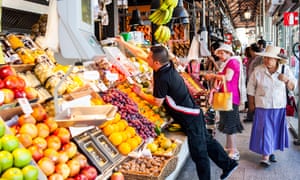 Elderly people shop for fruit and veg at the San Miguel market in Madrid
