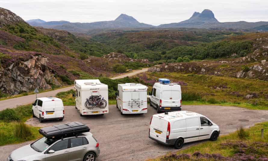 Tourist campers and motorhomes in car park at Lochinver in the Scottish Highlands, UK