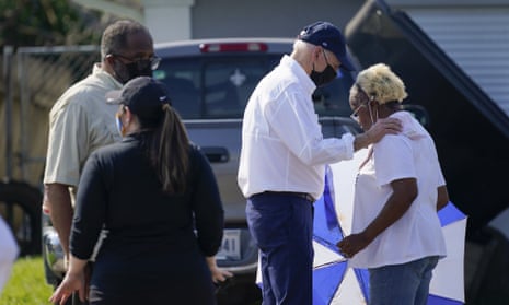 Joe Biden talks with a resident as he tours a neighborhood impacted by Hurricane Ida.