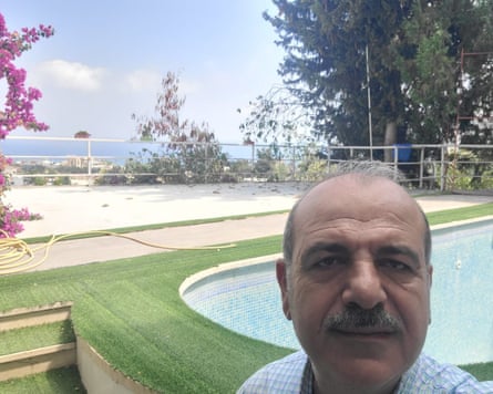 A selfie of a man next to an empty swimming pool