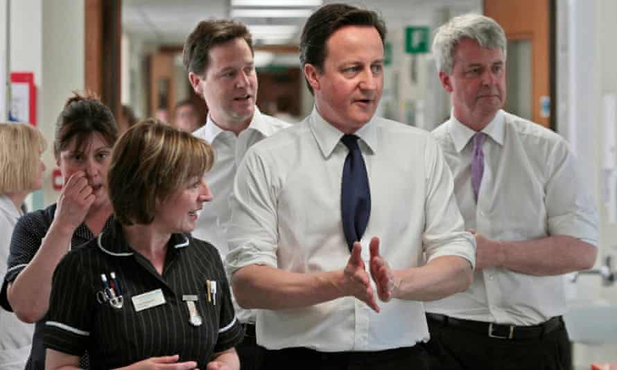David Cameron, Nick Clegg and Andrew Lansley speaking with staff at Frimley Park hospital in 2011.
