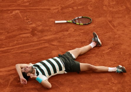 Carlos Alcaraz lies on his back after winning