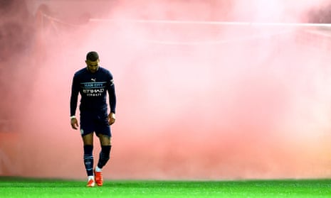 Consolation: Kyle Walker of Manchester City walks through a red smoke bomb thrown onto the pitch after Harry McKirdy of Swindon Town scores a goal to make the score 1-3 .