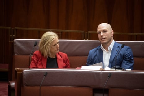Finance Minister Katy Gallagher talks to ACT independent senator David Pocock in the senate chamber of Parliament House in Canberra this afternoon.