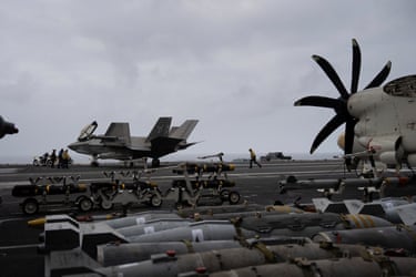 A sailor runs down the flight deck of the USS George Washington, which was deployed to relieve another carrier, the USS Abraham Lincoln.