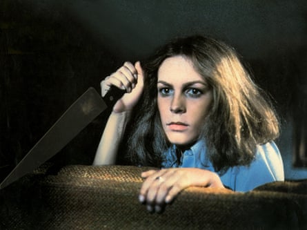 A female holding a weapon looking dangerously complete a bar.