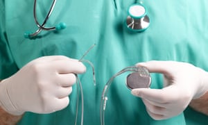 Surgeon Holding Heart Pacemaker