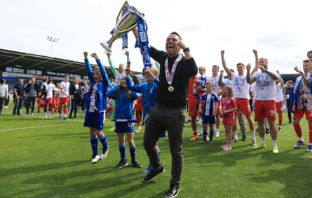 Leam Richardson leads the celebrations after Wigan won promotion in April