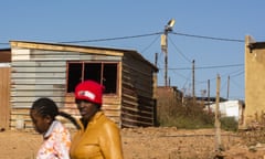 Eskom Holdings SOC Ltd. May Be ‘Too Big to Support’<br>Electricity cables run above residential shacks in the Atteridgeville township, Pretoria, South Africa, on Friday, May 31, 2019. While South African President Cyril Ramaphosa says power utility Eskom Holdings SOC Ltd. is considered too big to fail, it could be too big to support because of the costs associated with stabilizing its finances, Engineering News reported, citing S&amp;P Global Ratings Director Ravi Bhatia. Photographer: Waldo Swiegers/Bloomberg