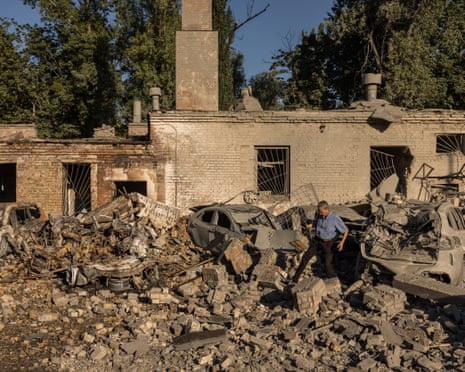 Residents walk through debris in a courtyard following a Russian missile strike on Kyiv.