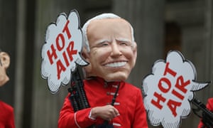 A protester wears a giant Joe Biden mask with a "hot air" speech bubble