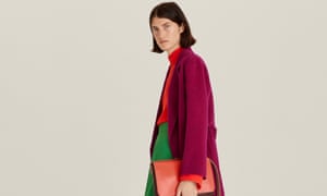 Model with red roll-neck sweater, green wide trousers and pink cardigan