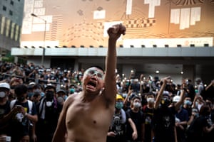 A man holds eggs in his hand to throw at the police as thousands of protesters surround the police headquarter in Hong Kong on June 21, 2019. Demands of the pro-democracy protesters grew to five, including retraction of the government labelling of protests as riots, the release of all arrested protesters, and an inquiry into police violence.