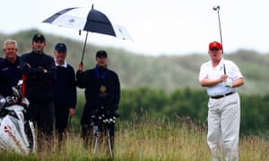 Donald Trump plays golf during the opening of his golf resort near Aberdeen.