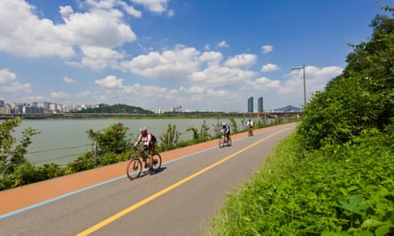 Cycling by the Seongsudaegyo Bridge Hangang river, Seoul, South Korea