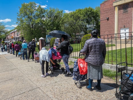 People wait in line in New York City to receive free food in May.