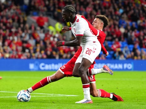 Denmark's Mohamed Daramy (right) is tackled by Wales' Ethan Ampadu.
