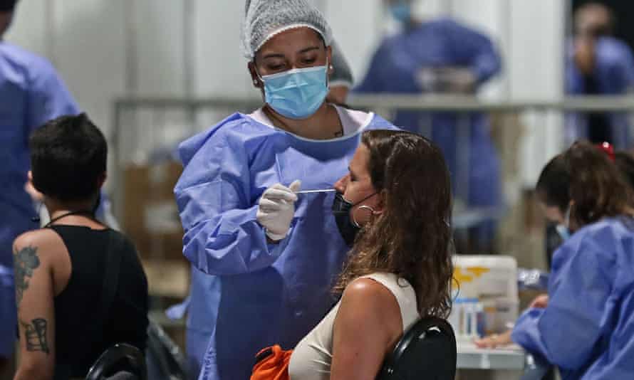Um profissional de saúde examina uma mulher para Covid-19 em um centro de testes gratuitos em Buenos Aires na segunda-feira.