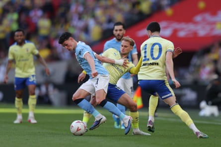 Phil Foden on the ball, under pressure from Southampton players