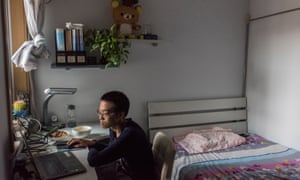 Yuan Qi in his bedroom at his parents' apartment.