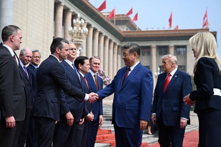 US President Donald Trump and China’s leader Xi Jinping greet officials during a welcome ceremony at the Great Hall of the People in Beijing