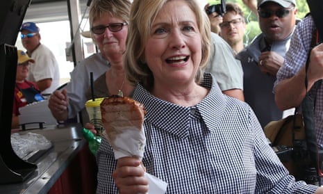 Hillary Clinton holds a pork chop on a stick as she tours the Iowa State Fair in August 2015.