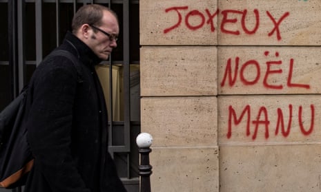 Graffiti on a wall near the Champs Élysées reads ‘Merry Christmas, Manu’ as anger at Emmanuel Macron’s government spilled over into a fourth weekend of violent protests.