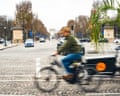 A blurred picture of a cyclist speeding past the Champs-ĂlysĂŠes in Paris