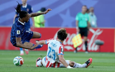 Matias Galarza (right) of Paraguay fouls Michael Olise of France.