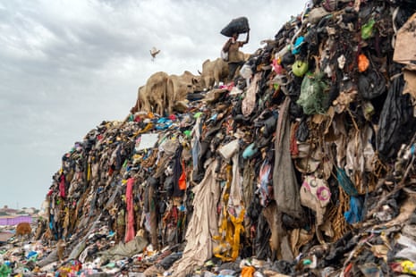 Cheap disposable secondhand fashion rotting in landfill in Accra, Ghana.
