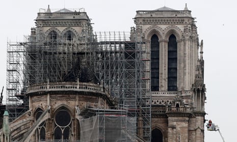 Firefighters worked to put out residual fires at Notre Dame early on Tuesday.