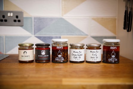 Jars of chilli crisp by Yok Chan, Ana Morales and Mama Yu lined up on a kitchen counter