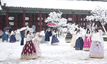Visitors enjoy snow at Gyeongbok Palace, one of South Korea’s best-known landmarks, in Seoul