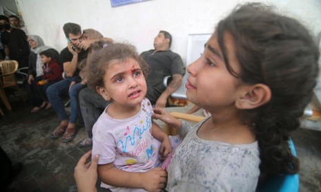 Injured Palestinian children react as they wait at the hospital to be checked, as battles between Israel and the Hamas movement continue for the sixth consecutive day in the city of Rafah, in the southern Gaza Strip.