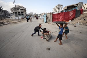 Children playing in a road in between buildings destroyed by airstrikes