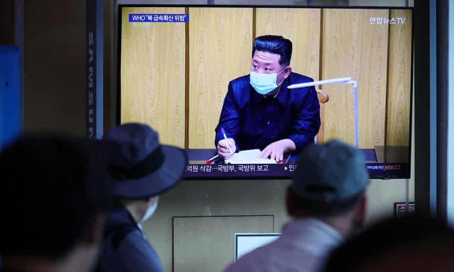 People watch a news report on the coronavirus outbreak in North Korea, 17 May.