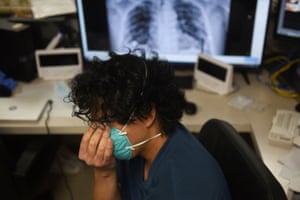 A medical professional touches his face as patients infected with Covid-19 are treated at United Memorial Medical Center in Houston, Texas on 12 November 2020