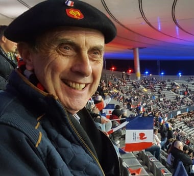 Mark Noble, 75, during a Rugby game, cheering on the French side.