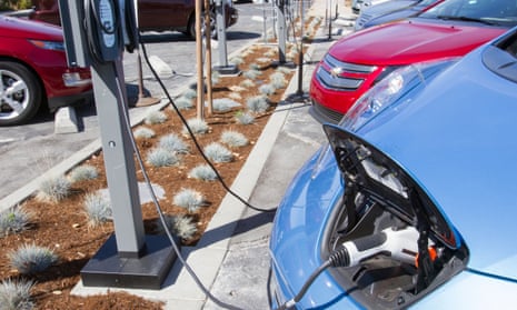Electric cars plugged into a charging point