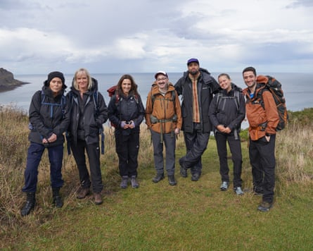 Patsy Kensit, Hermione Norris, Jayne Middlemiss, Ashley Blaker, Ashley Banjo, Tasha Ghouri, Hasan Al Habib stand together with the sea behind them.