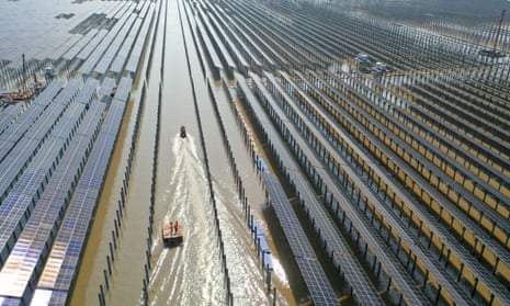 Aerial photo of photovoltaic field in water.