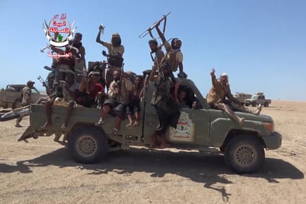 Yemeni Southern Giants Brigades fighters celebrate and wave weapons riding in a pickup truck