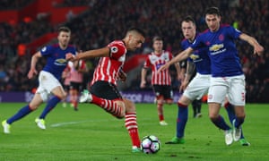 Dusan Tadic of Southampton shoots as Matteo Darmian of Manchester United attempts to block.