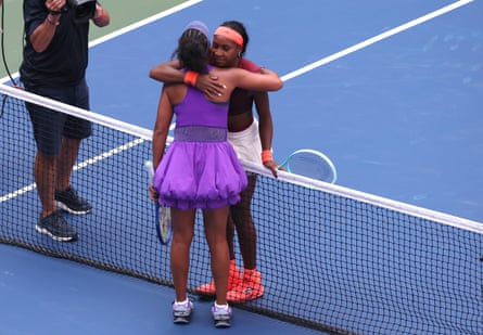 Naomi Osaka (left) and Coco Gauff embrace at the net
