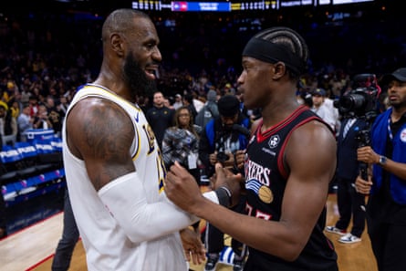 LeBron James (left) talks with the 76ers’ VJ Edgecombe after a game last season in Philadelphia.